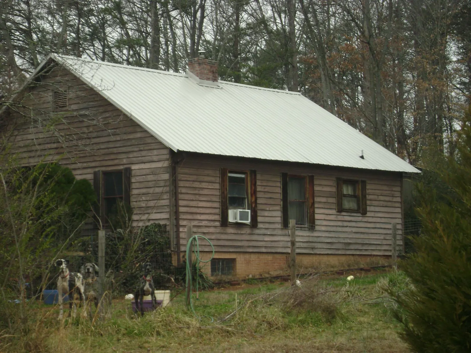 White metal roof on an old wood sided farmhouse, from a Metal Roof Installation job in Ball Ground